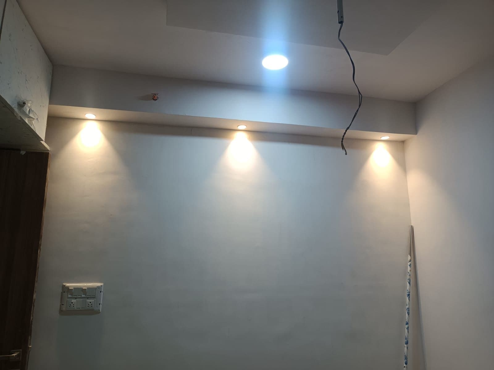 False ceiling with a row of recessed spotlights freshly wired and tested