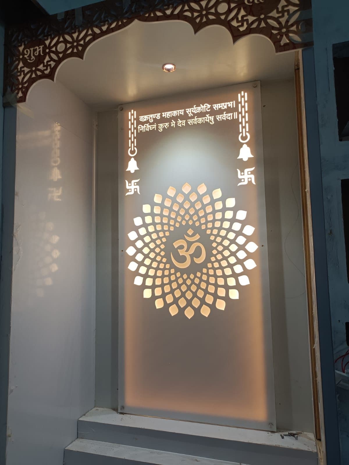 Backlit home mandir unit with laser-cut Om jaali design and warm LED lighting